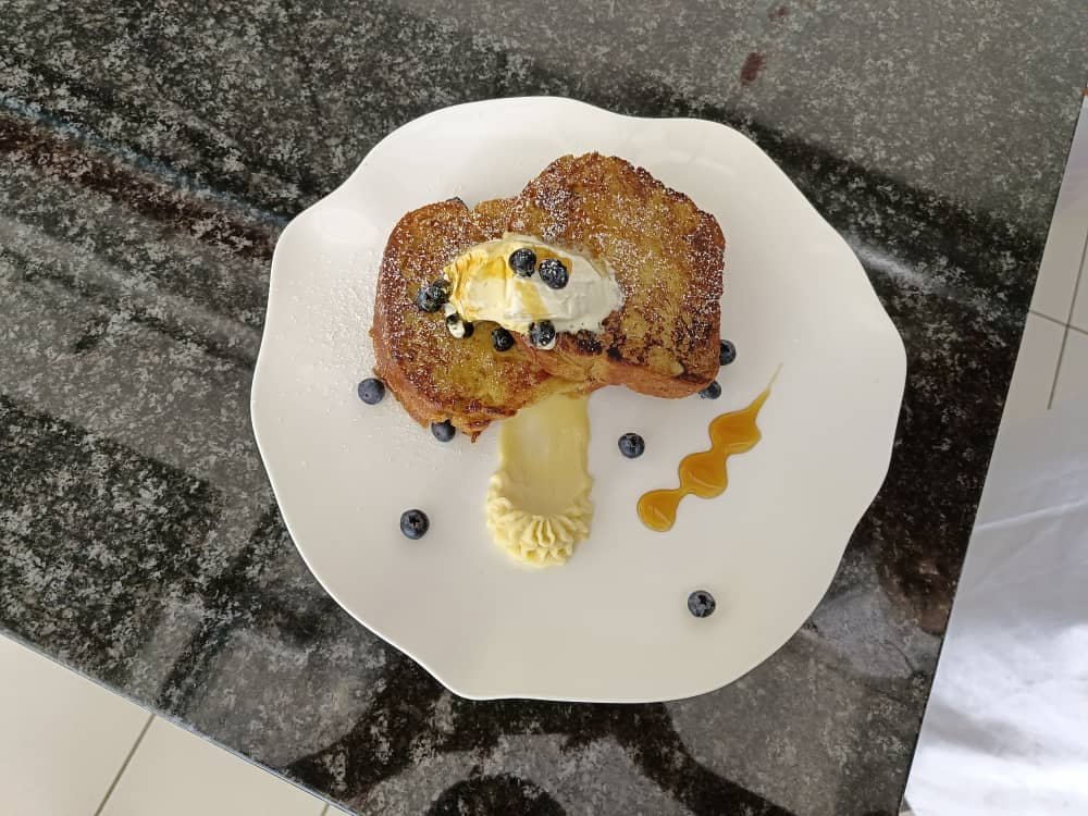 French toast with white ganache and honey glazed with fresh blueberries