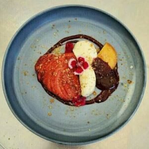 Poach pear, ricotta cream with Sable cookies and Berry coulis