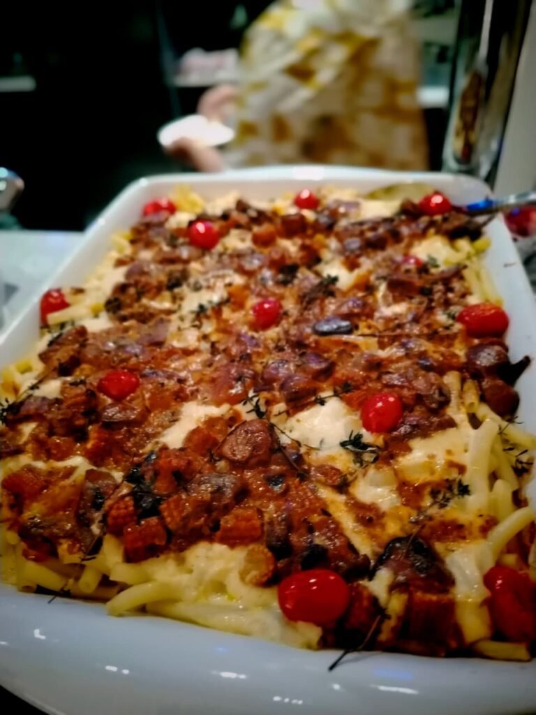 Mac and cheese topped with creamy mushroom and corn